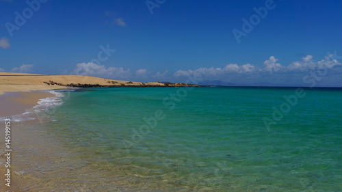 Turquoise water at holiday beach of Corralejo on the island of Fuerteventura