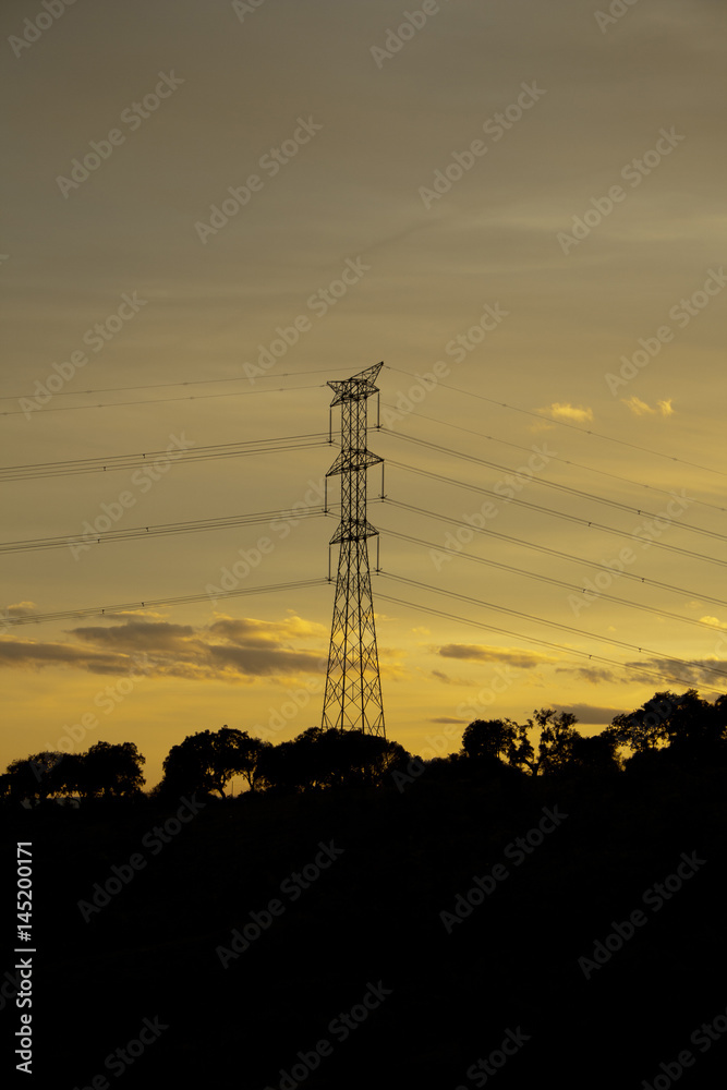 Towers supporting power lines at dusk