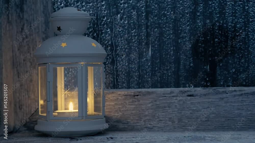 Lighthouse lit on the roof of an old window, it rains outside Lighthouse lit on the roof of an old window, it rains outside