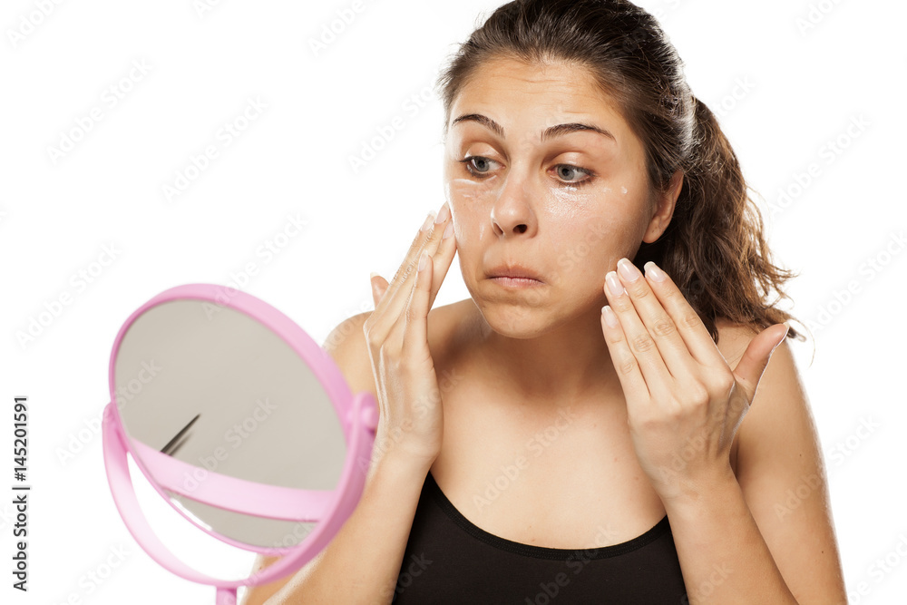 young beautiful women apply cosmetics on her face young beautiful women apply cosmetics on her face