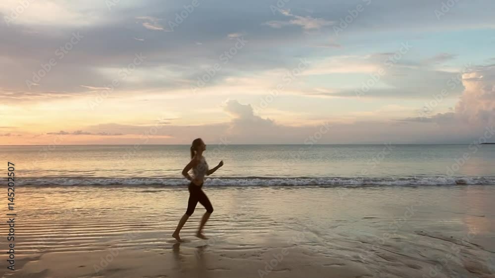 Silhouette of a Woman Running on the Beach Silhouette of a Woman Running on the Beach