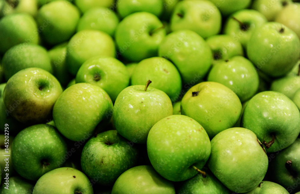 Green delicious apples in packing tub at fruit warehouse Green delicious apples in packing tub at fruit warehouse