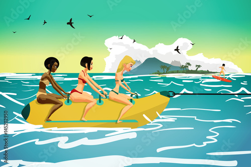 Young women ride a banana. Girls in the summer on the beach. Fla