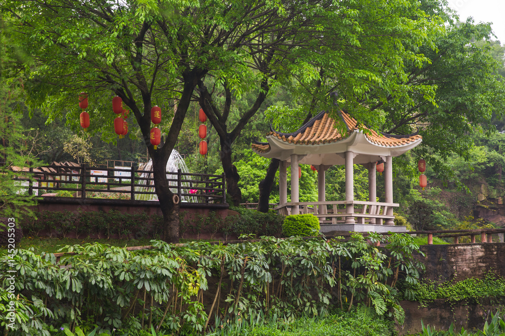 Pavilion with traditional Chinese roof and red lights on tree Pavilion with traditional Chinese roof and red lights on tree