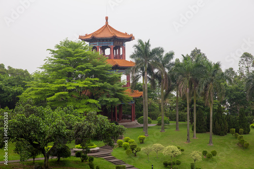 Three-story palivion with  traditional Chinese roof in  park photo