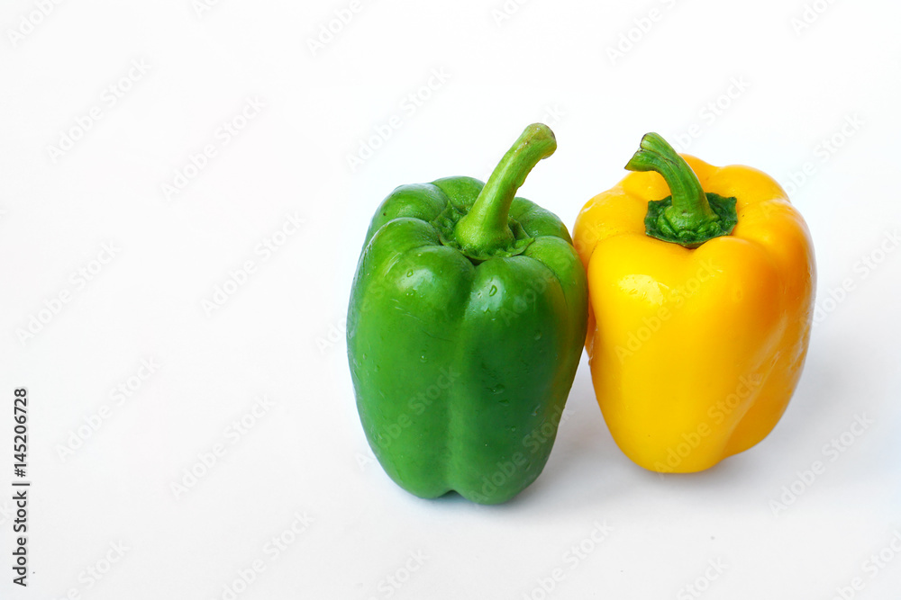 Group of sweet green peppers and yellow peppers, also known as Bell pepper or Capsicum - Fresh vegetables isolated on white background. Group of sweet green peppers and yellow peppers, also known as Bell pepper or Capsicum - Fresh vegetables isolated on white background.