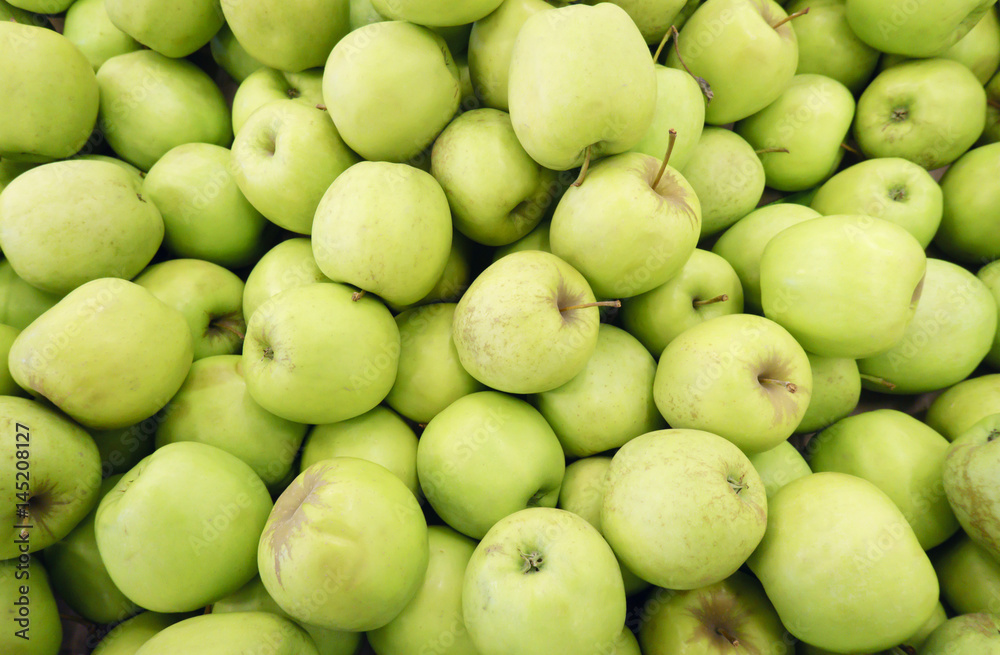 Closeup of many green juicy apple fruits in market Closeup of many green juicy apple fruits in market