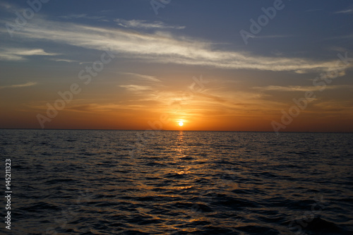 Picturesque sunset by sea shore © snedorez