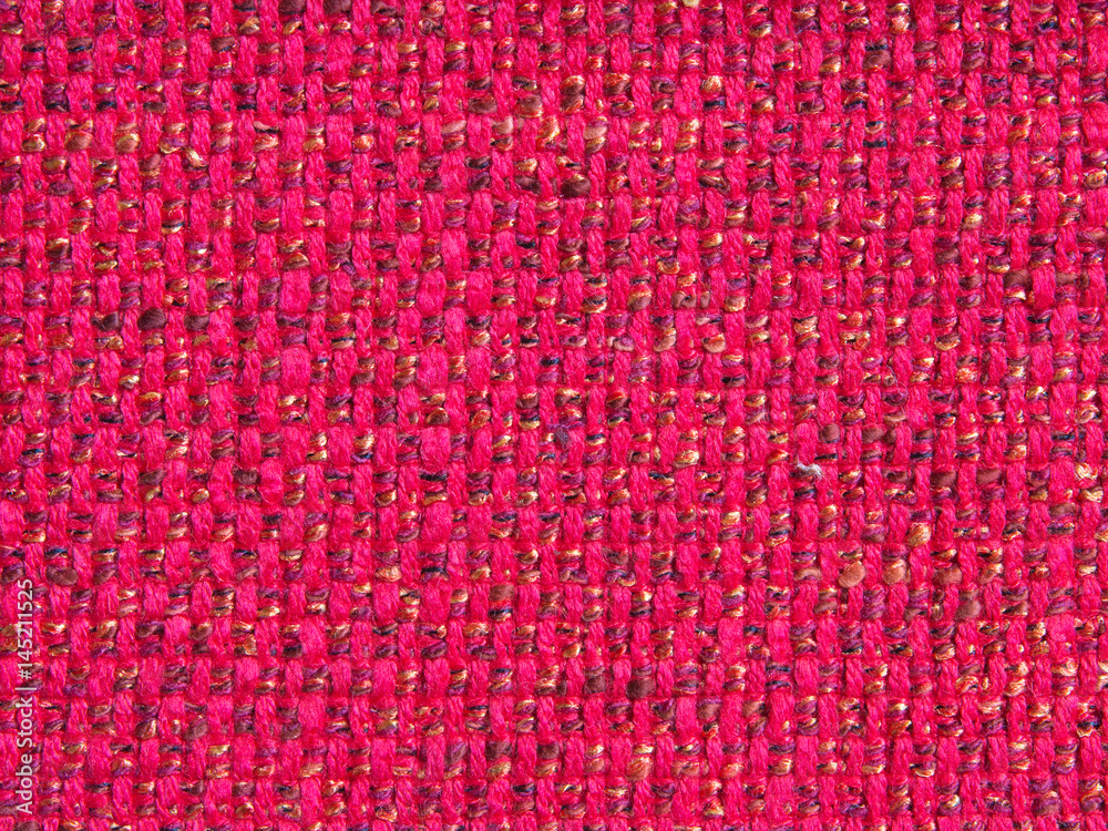 Texture of old textile vintage background with a pattern of red color closeup