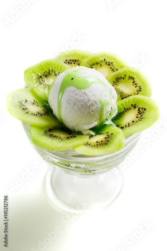 Swwet and sour kiwi ice cream and whipped cream photo