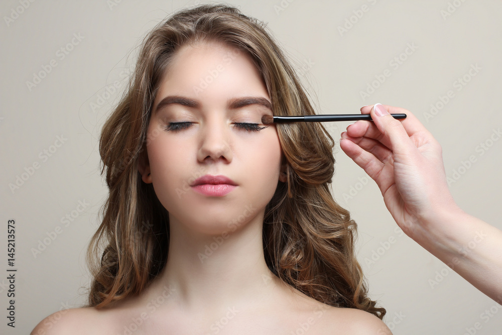 Make-up artist does make-up model