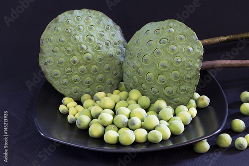 Lotus seed pod and lotus seeds on ceramic plate. photo