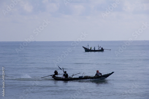 two boat and fishermen are fishing 