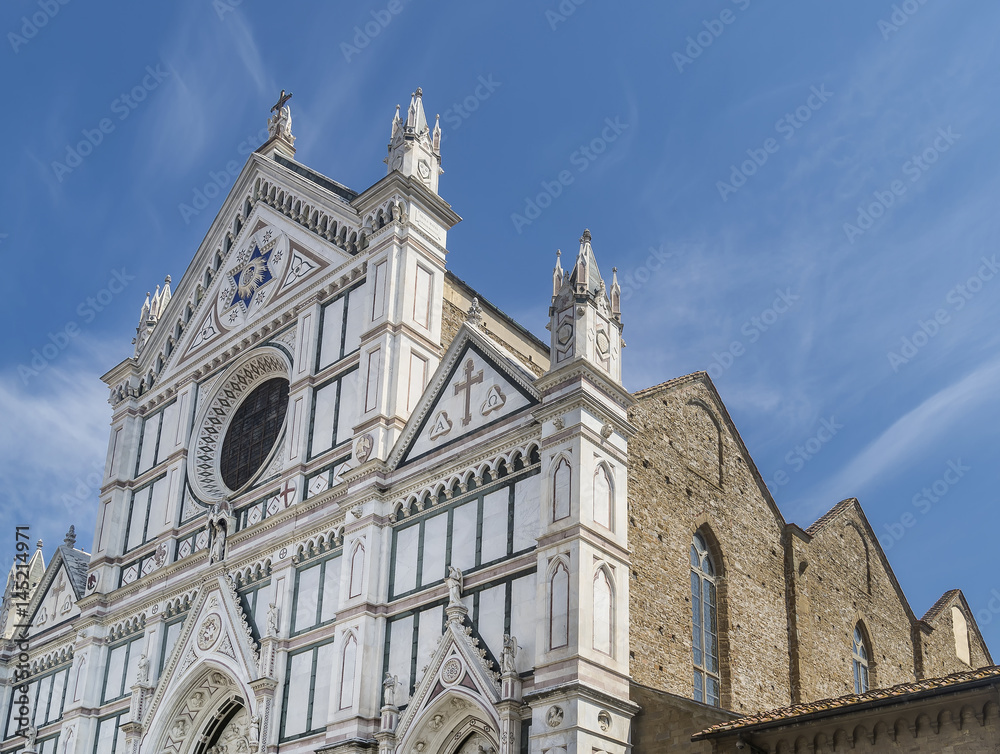 Detail of the facade of the famous Basilica di Santa Croce in the historic center of Florence, Italy, on a sunny day and blue skies