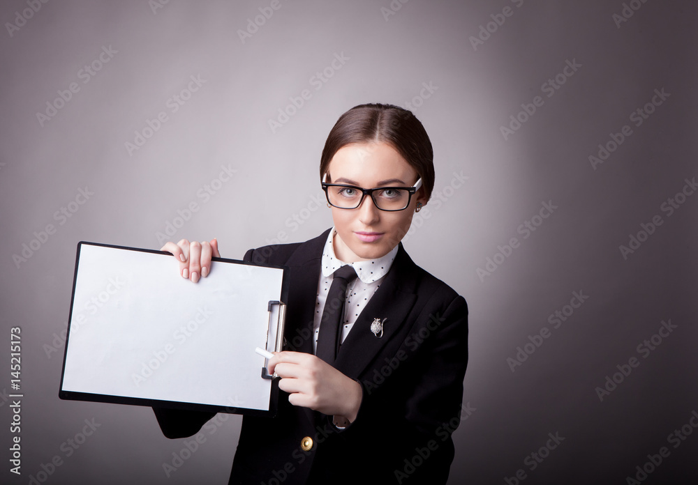 Young girl businesswoman with folder on gray background in studio Young girl businesswoman with folder on gray background in studio