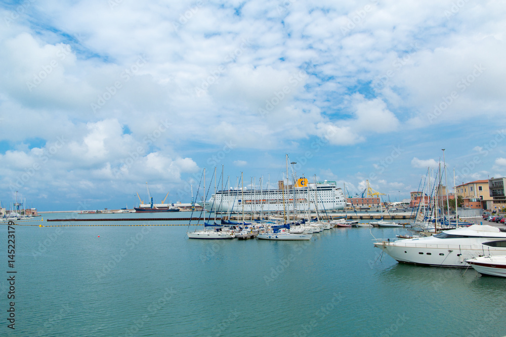 View of port with yachts, naval ships and industrial vessels