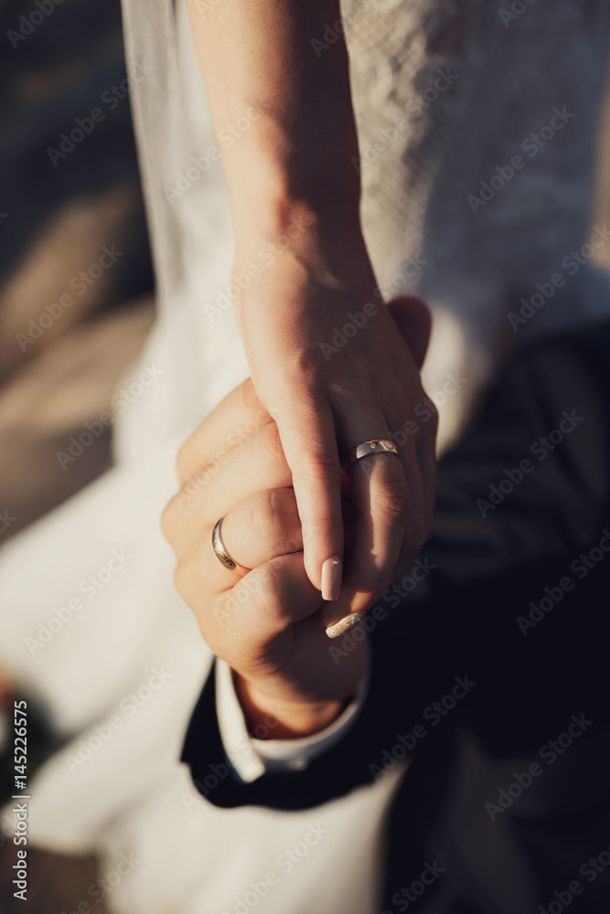 Bride and groom hold each other hands tender Bride and groom hold each other hands tender
