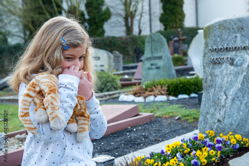 sad girl in front of grave