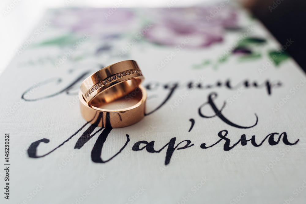 The wedding rings for brides stand on the table The wedding rings for brides stand on the table