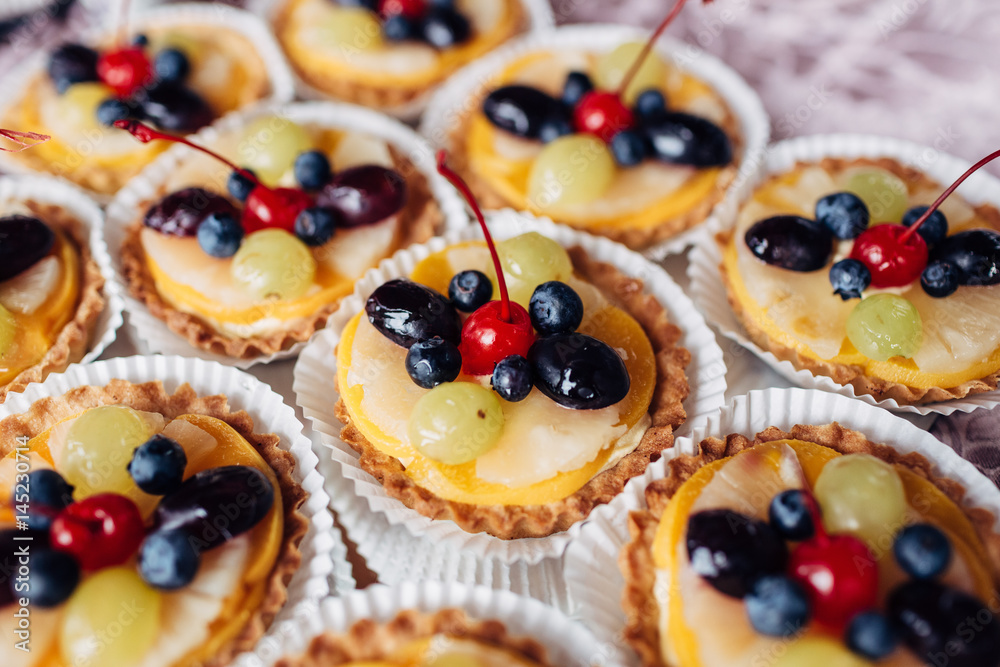 The baked baskets with fruits standing on the buffet table The baked baskets with fruits standing on the buffet table