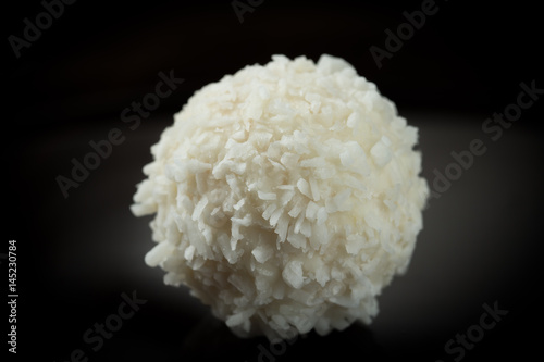 One sweet round coconut candy isolated close-up