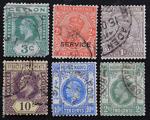 A series of old postage stamps of English colonies.