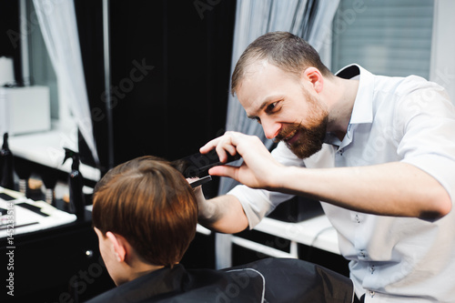 cute young boy getting a haircut