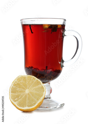 Glass cup with tea and lemon on white background