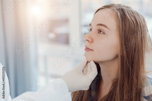 Experienced pediatrician examining patient face in the hospital