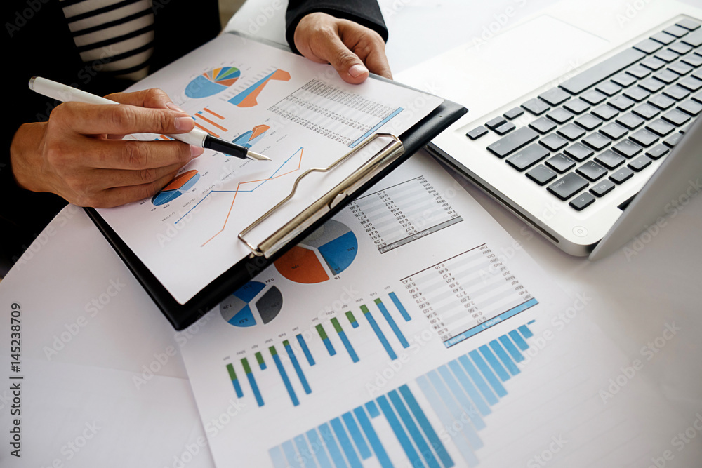 Business concept. Business people discussing the charts and graphs showing the results of their successful teamwork. Selective focus. Business concept. Business people discussing the charts and graphs showing the results of their successful teamwork. Selective focus.