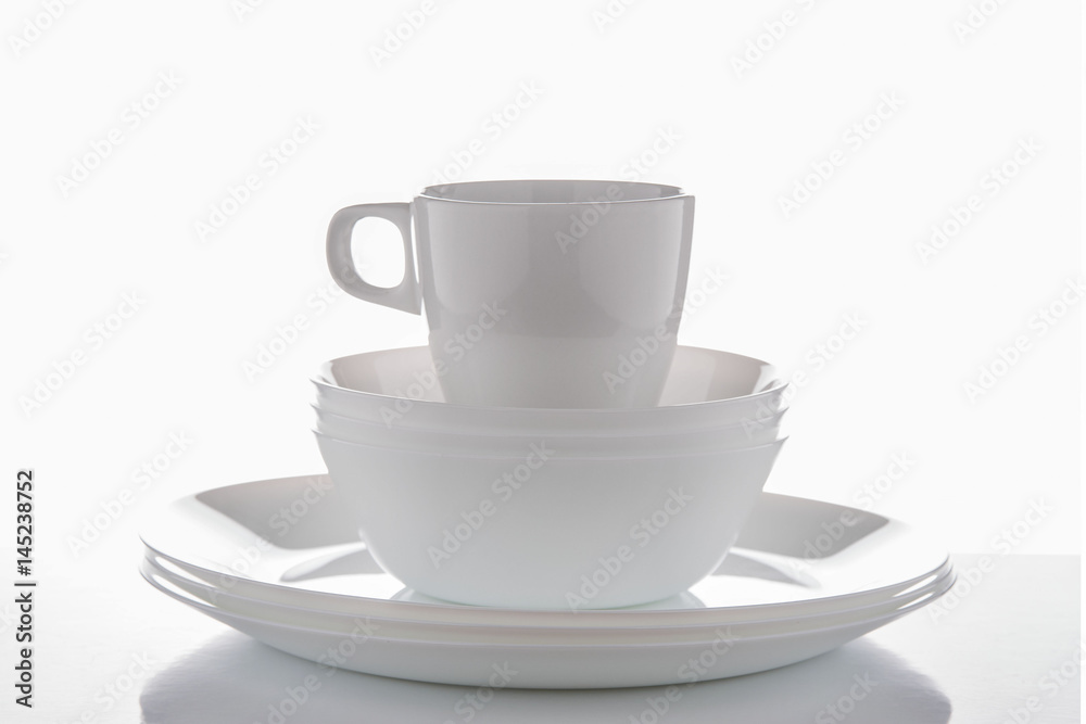 White crockery on a white background with reflections White crockery on a white background with reflections