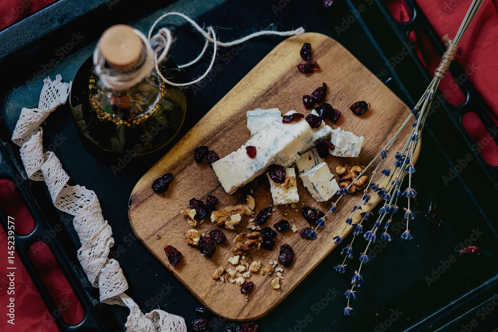Cheese plate: cheese,  walnuts,  raisins