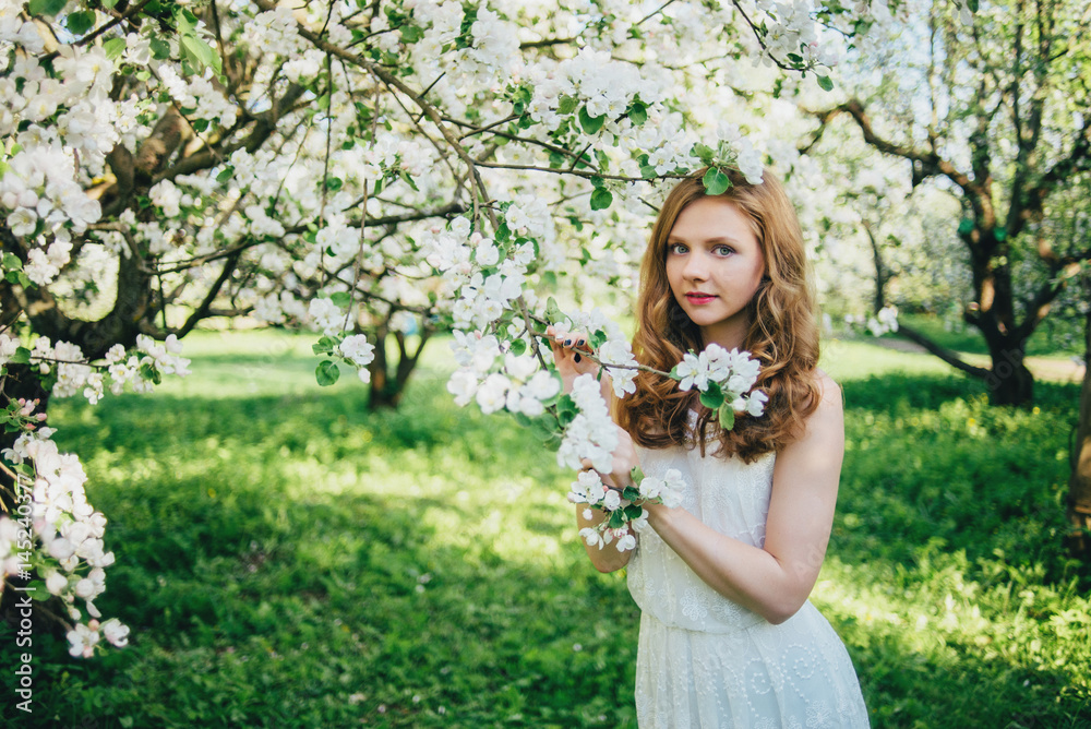 A girl in a blooming garden A girl in a blooming garden