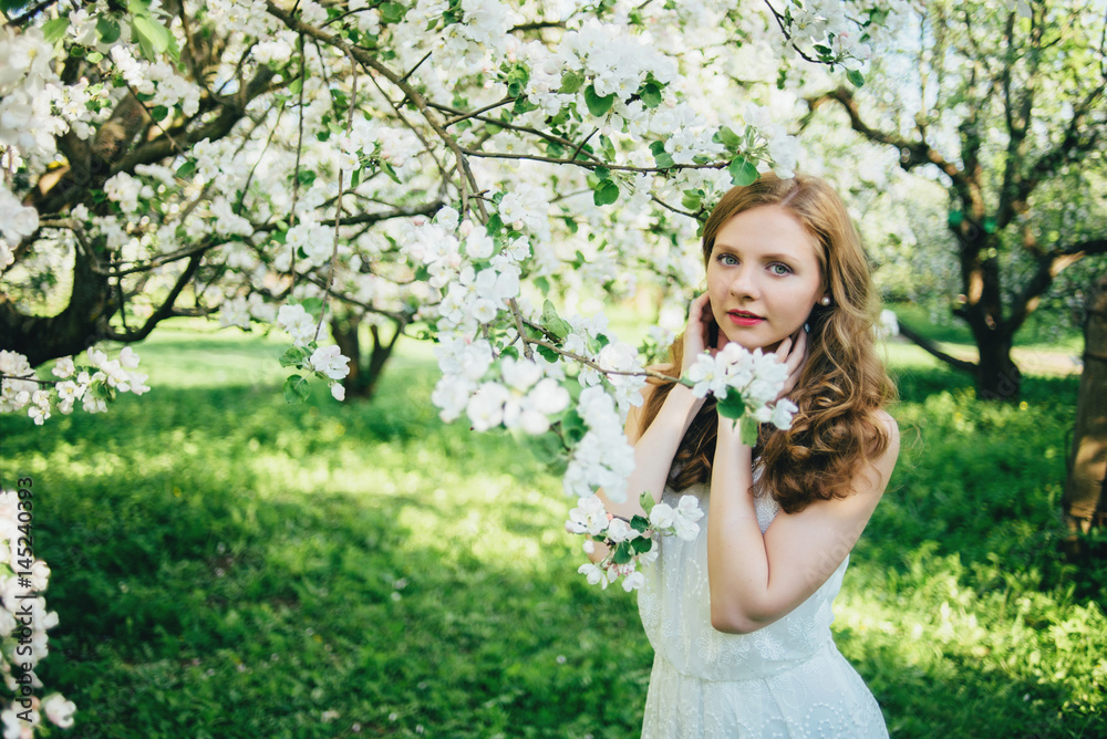 A girl in a blooming garden A girl in a blooming garden