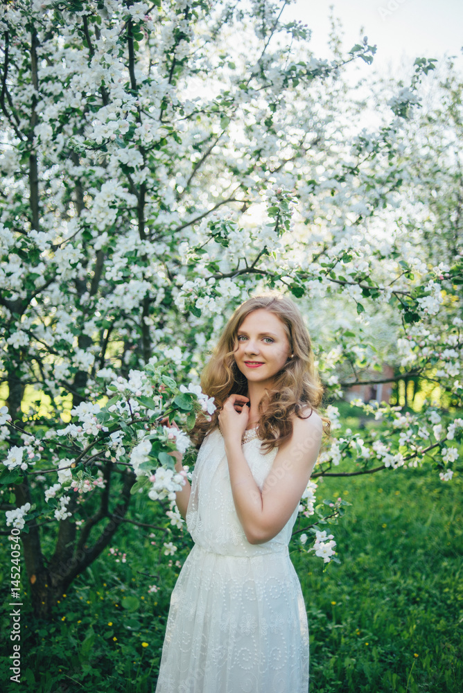 A girl in a blooming garden A girl in a blooming garden