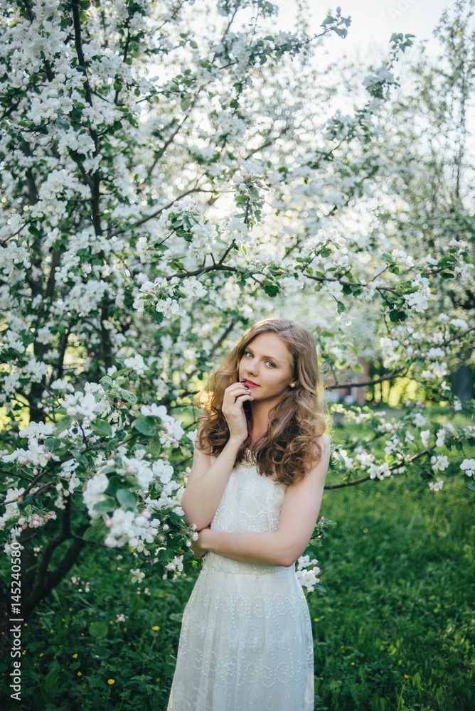 A girl in a blooming garden A girl in a blooming garden