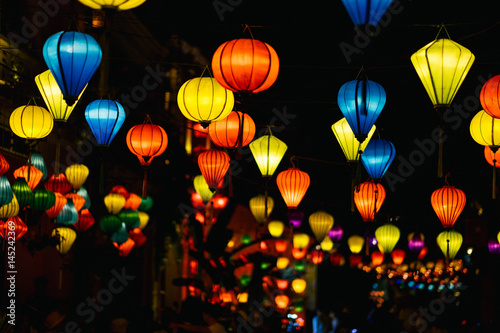 Look from below at paper lanterns shining in the night sky