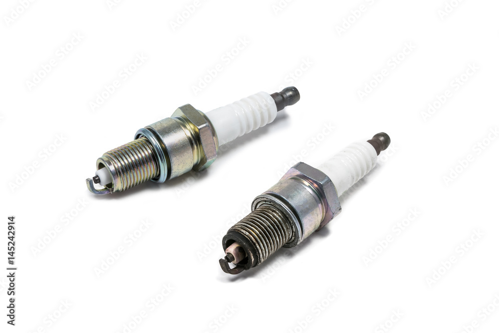 New and old spark plugs. Isolated on white background New and old spark plugs. Isolated on white background