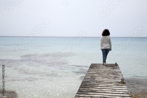 Woman on Pier and Jetty, Valencians Beach; Formentera photo