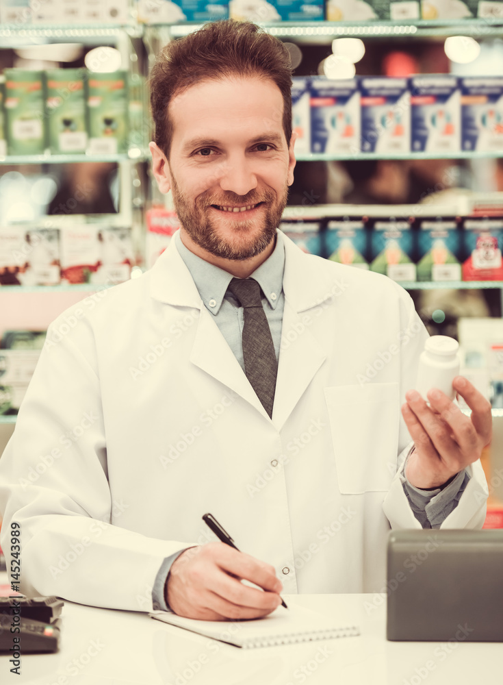 Handsome pharmacist at work