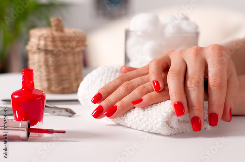 Stampa su tela Hand care. Beautiful manicure, woman's hands with red nails