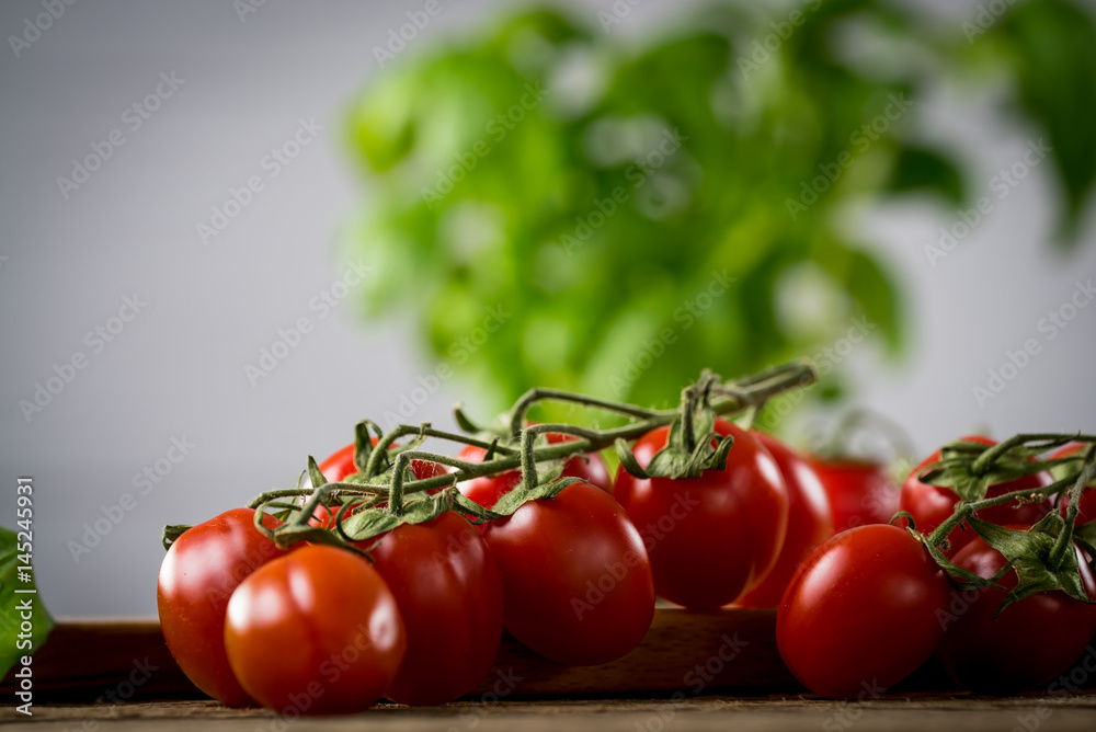 Fresh cherry tomatoes on rustic wooden table, Top view with copy space. Fresh cherry tomatoes on rustic wooden table, Top view with copy space.