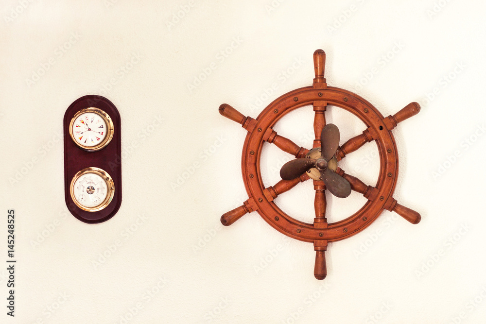 Fototapeta premium Sea wheel and propeller of a ship on a white wall