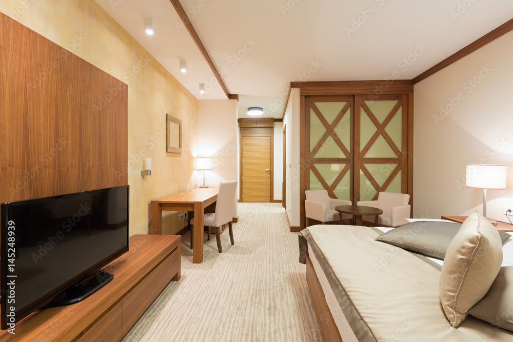 Naklejka premium Hotel apartment, bedroom interior in the evening