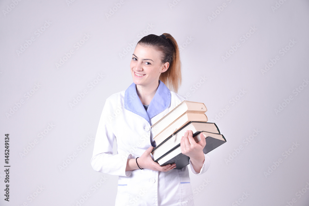 Young nurse  with books portrait education concept