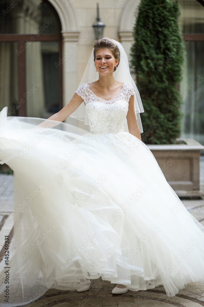 Gorgeous bride smiles while she whirls Gorgeous bride smiles while she whirls
