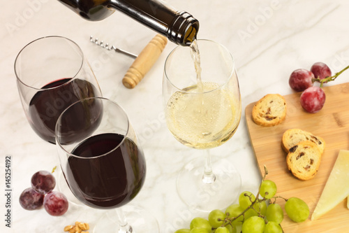 Wine, cheese, bread, and grapes at tasting