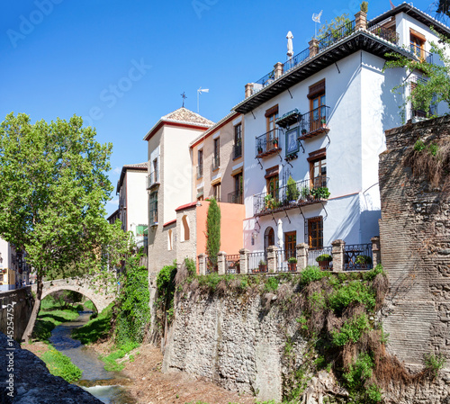 Fototapeta Naklejka Na Ścianę i Meble -  Old buildings on Carrera del Darro street in beautiful spring day, Granada, Spain.