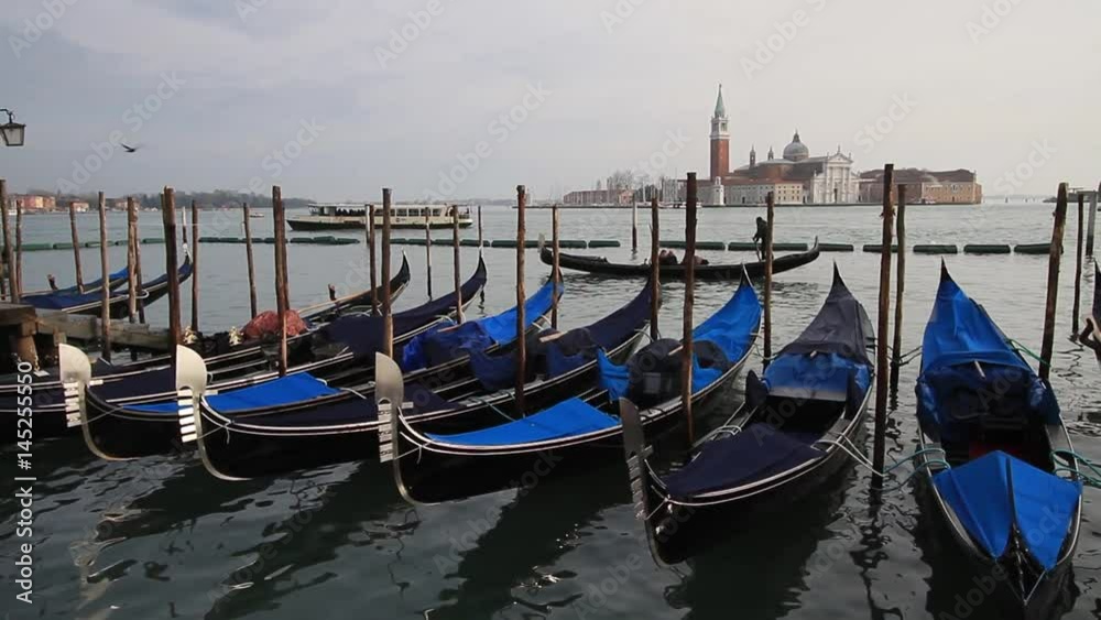 Venice, February 2017: Traditional boat Gondola with tourists in venetian canal, on February 2017 in Venice, Italy, Europe Venice, February 2017: Traditional boat Gondola with tourists in venetian canal, on February 2017 in Venice, Italy, Europe