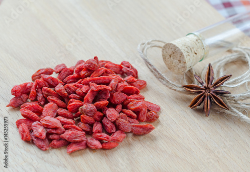 Goji berries and clove on a wooden Board.